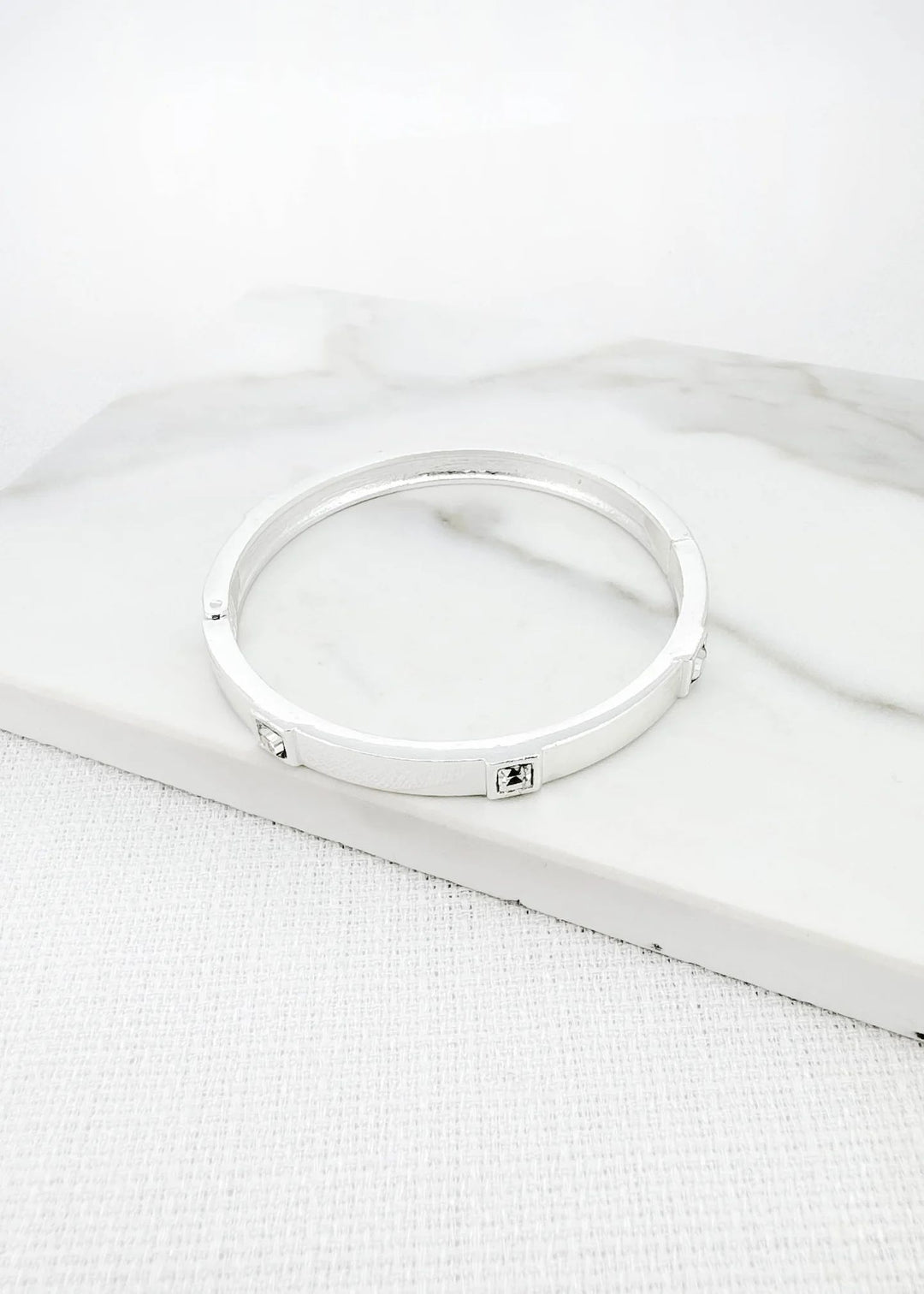 Envy silver hinged bangle with clear faceted glass detail